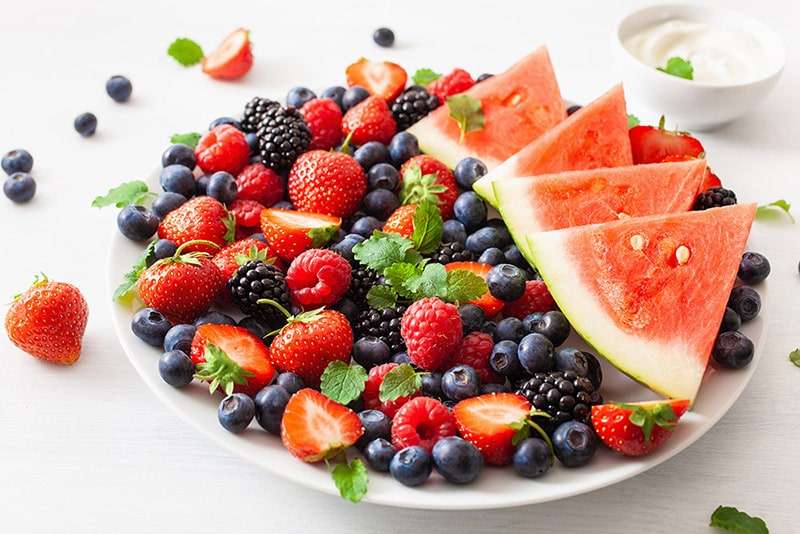 bowl of fruit including watermelon, blueberries, blackberries and strawberries.
